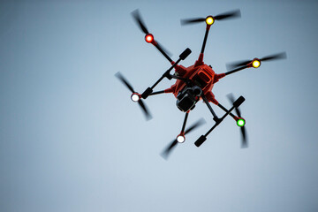 Yuneec H520 RTF Hexacopter drone with thermal imager hovering above viewer in dusk sky, motion blurred propellers