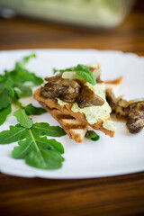 fried toast with cheese spread, arugula and fried mushrooms
