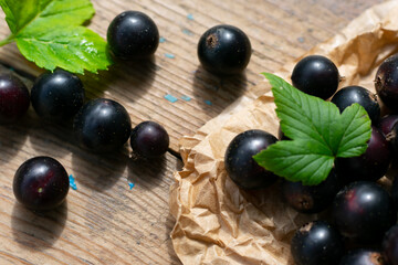 Sweet ripe raw black currants on wooden table freshly picked berries, vitamin C source, vegetarian food
