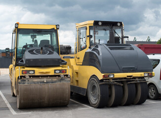 Two types of asphalt rollers next to each other close