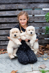 Little Girl Playing With Golden Retriever Puppy