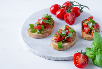 bruschetta with tomatoes and basil on fried in olive oil rye baguette