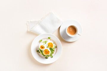 Avocado egg sandwich and cup of coffee