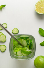 A glass of detox water infused with cucumber and mint, with ingredients. Health care, fitness, healthy food concept. Top view.