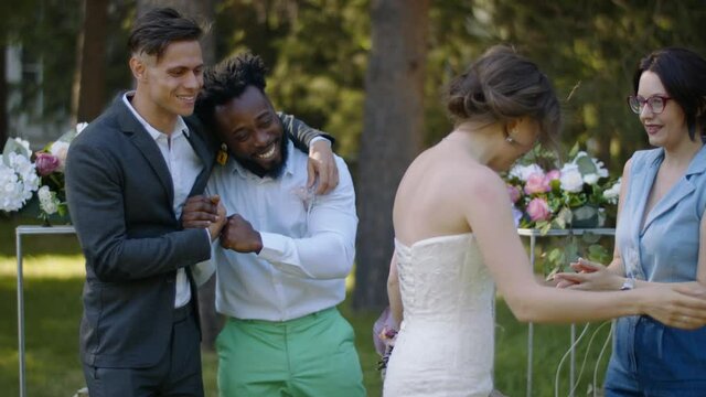 Newlyweds accept congratulations from guests at a multi-ethnic wedding
