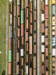 Freight trains on railway tracks. Aerial drone top view. Sunny spring day.