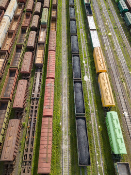 Freight trains on railway tracks. Aerial drone top view. Sunny spring day. © Sergey