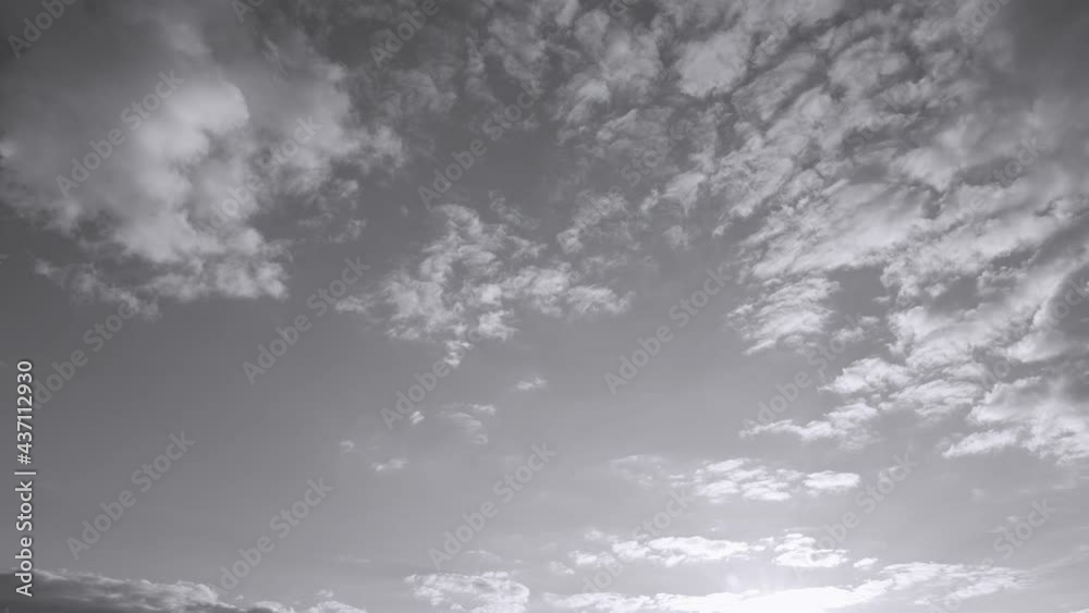 Wall mural sunset time and clear blue sky with some white fluffy clouds. black and white real time 4k video foo