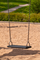 Swing with a metal chain in the park