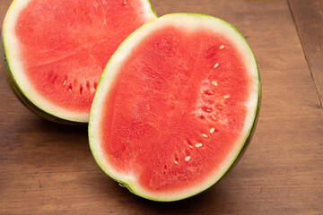 Fresh watermelon cut in half on a farm table