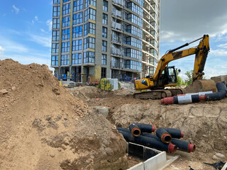 Excavator dig the trenches at a construction site. Trench for laying external sewer pipes. Sewage...