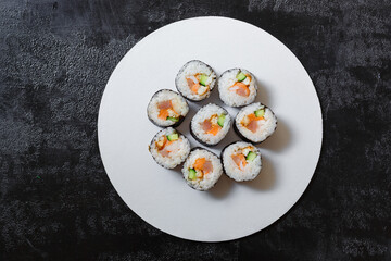 sushi rolls with salmon on a plate