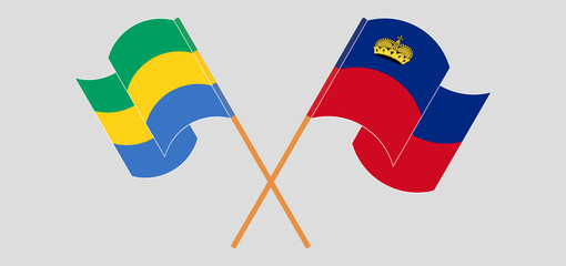 Crossed and waving flags of Gabon and Liechtenstein