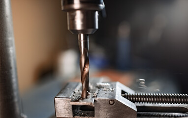 Drill close-up at the workplace in workshop