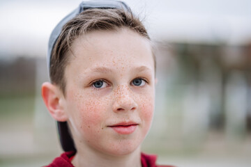 Close-up portrait of teenage boy with freckles on his face