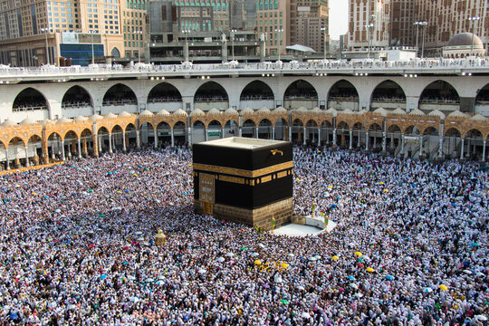 Holy Kaaba. Crowd of people always walking around Kaaba. Ritual of circumambulation - tawaf during Hajj. Mecca - Saudi Arabia