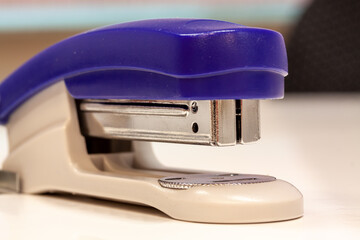 Closeup shot of a blue stapler on a white background