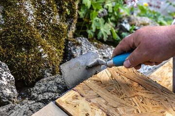 a person processing concrete on a do it yourself garden project