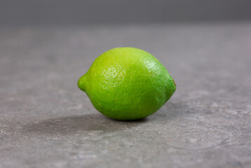 Fresh lime on a gray stone background