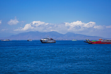 Ferries and boats sailing up and down the sea channel between Bali and Java islands, from Ketapang port to Gilimanuk port, Indonesia