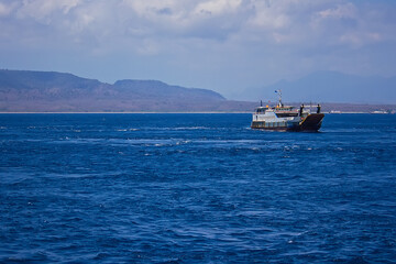Ferries and boats sailing up and down the sea channel between Bali and Java islands, from Ketapang port to Gilimanuk port, Indonesia
