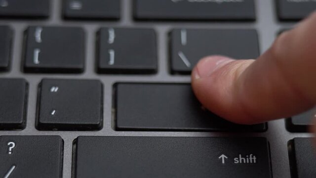 Enter button pressing a lot of times on keyboard, laptop keyboard close up