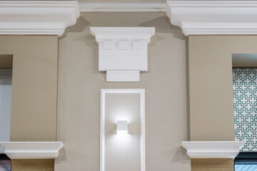 Detail of corner ceiling with intricate crown molding on column with spot light