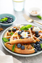 Almond waffles with nuts, ricotta cheese and fresh blueberries, healthy food, breakfast. Waffles with berries.