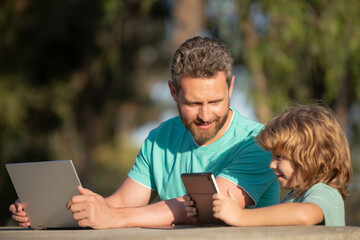 Online learning. Family education Concept. Father teaching his little toddler son use computer, laptop or tablet.