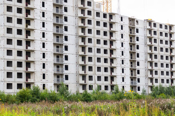 Construction of buildings. Multi-storey residential construction. Concrete frame of the house. Residential complex in nature