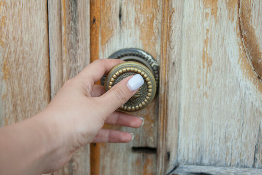 Woman Opening Old Door