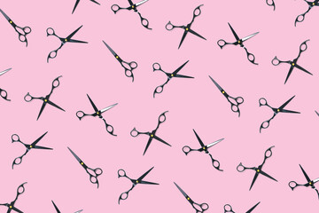 Background of black scissors. professional hairdresser black scissors isolated on pink. Black barber scissors, close up. pop art background, for prints or posters. not seamless pattern