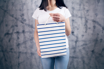 young woman holding a gift bag