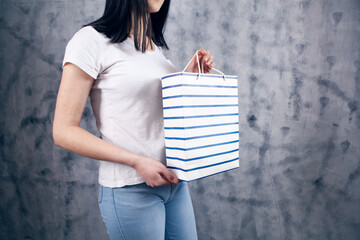 young woman holding a gift bag