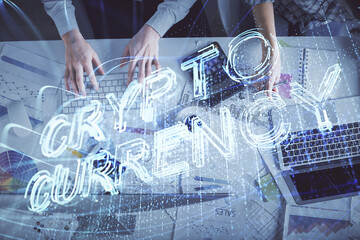 Double exposure of man and woman working together and crypto theme hologram drawing. Computer background. Blockchain concept. Top View.