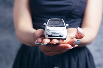 young woman holding a car