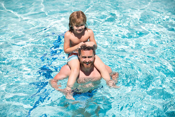 Father and son in pool. Family summer vacation. Pool party. Boy with father in swimming pool.