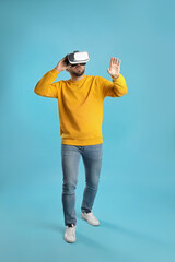 Man using virtual reality headset on light blue background