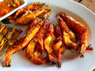 Golden fried shrimp on a white plate at a restaurant in Bali, Indonesia