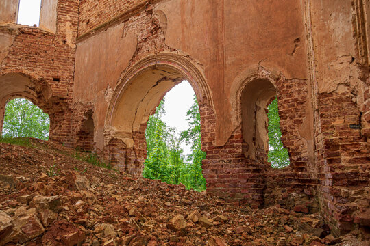 An arch in an abandoned old church made of red brick. View from the inside. Russia, Smolensk region, 1753.