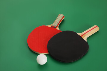 Rackets and ball on green background. Ping pong