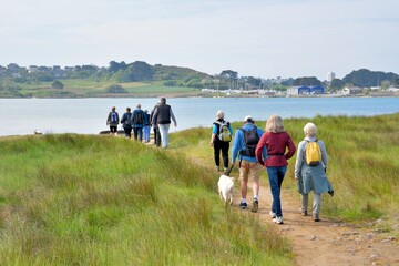 group of senior hikers on the path at "Ile Grande" in Brittany. France