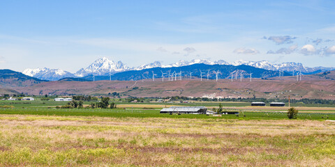 The Kittitas Valley in late Spring as the Stuart Range in the Cascade Mountains rise above the wind...