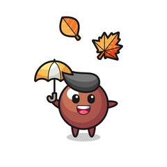 cartoon of the cute chocolate ball holding an umbrella in autumn
