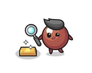 Obraz premium chocolate ball character is checking the authenticity of the gold bullion