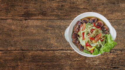 Som Tum or Thai spicy fresh young papaya salad with cockle