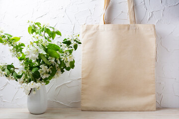 Rustic tote bag mockup with  flowering apple tree branch - obrazy, fototapety, plakaty