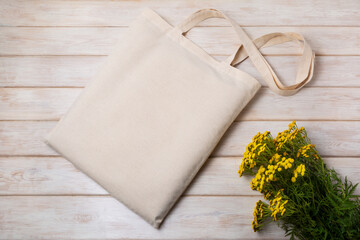 Rustic tote bag mockup with yellow wildflowers