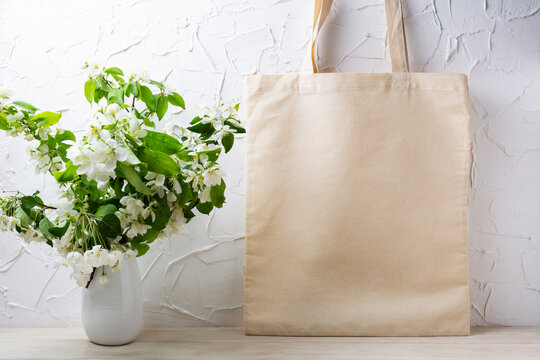 Rustic tote bag mockup with  flowering apple tree branch