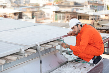 Fototapeta premium engineer or technician checking and fixing solar panels on the top of the roof